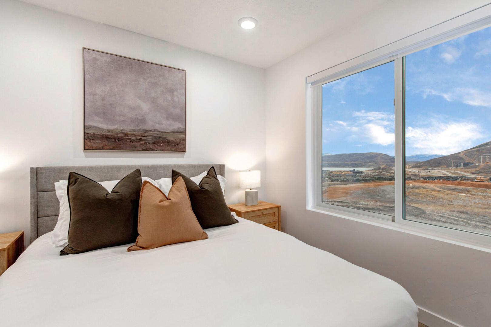 Wake up to breathtaking mountain vistas from your cozy bedroom, where plush bedding and serene decor create your perfect retreat.