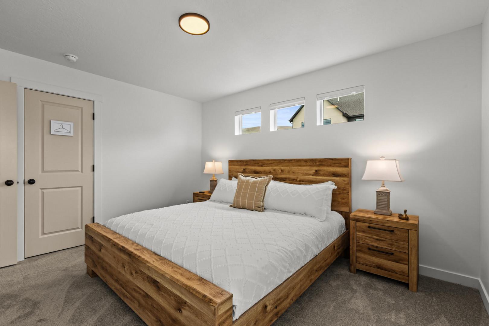 Drift off peacefully in your cozy bedroom, featuring a comfortable bed with crisp linens and warm rustic wood furnishings that create the perfect retreat.