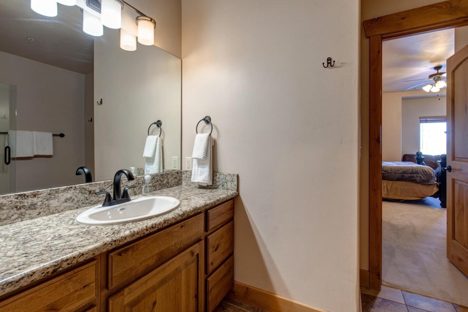 Your private vanity features granite countertops and elegant fixtures, with a peaceful bedroom just steps away.