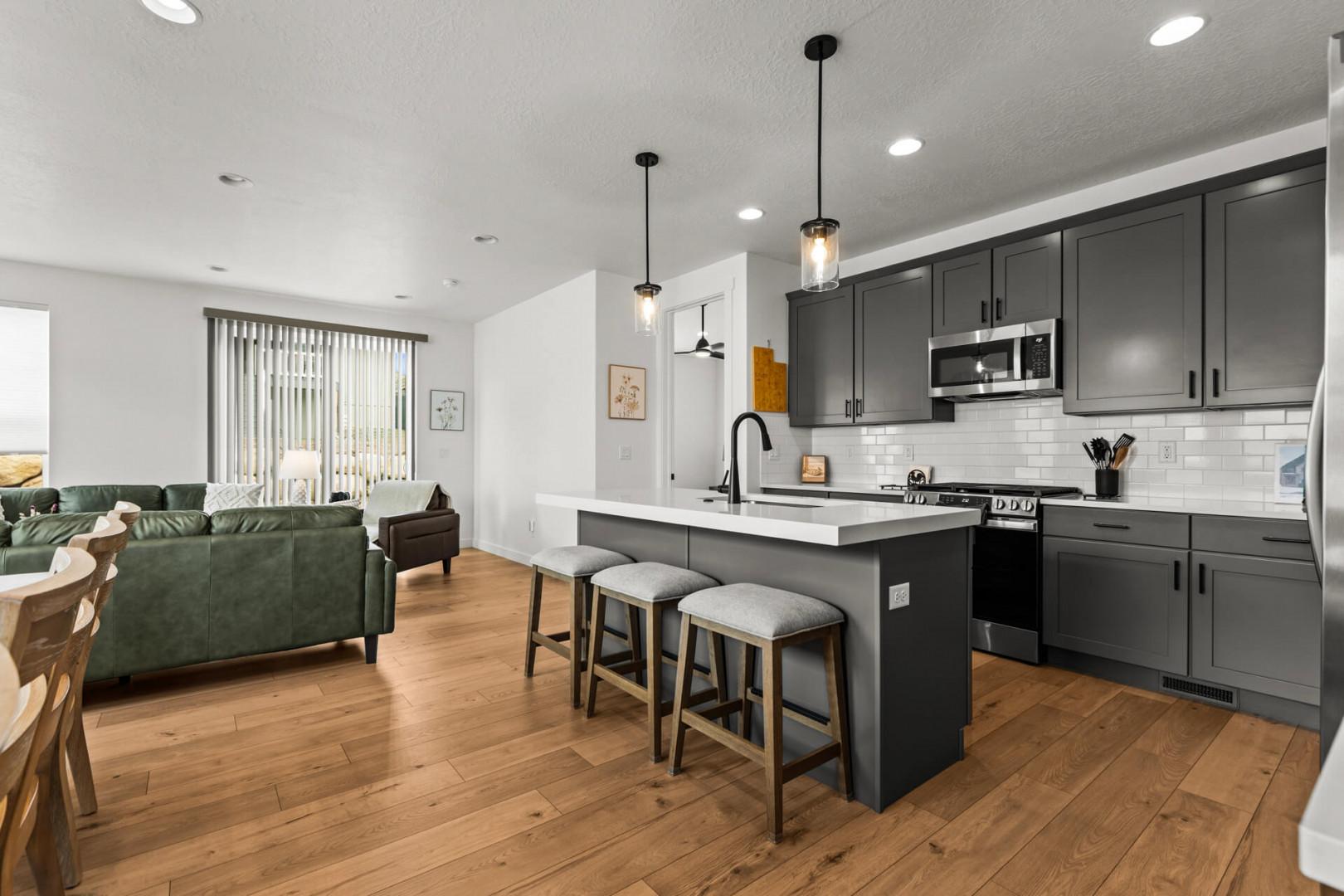 Your stylish open-concept haven features a fully equipped kitchen with granite counters and modern appliances, flowing seamlessly into the cozy living area.