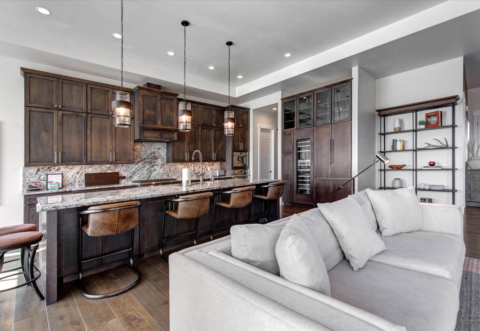 Deer Springs 12797: In the center of the kitchen is a spacious island with casual barstool seating that’s illuminated by unique, modern pendant lights.