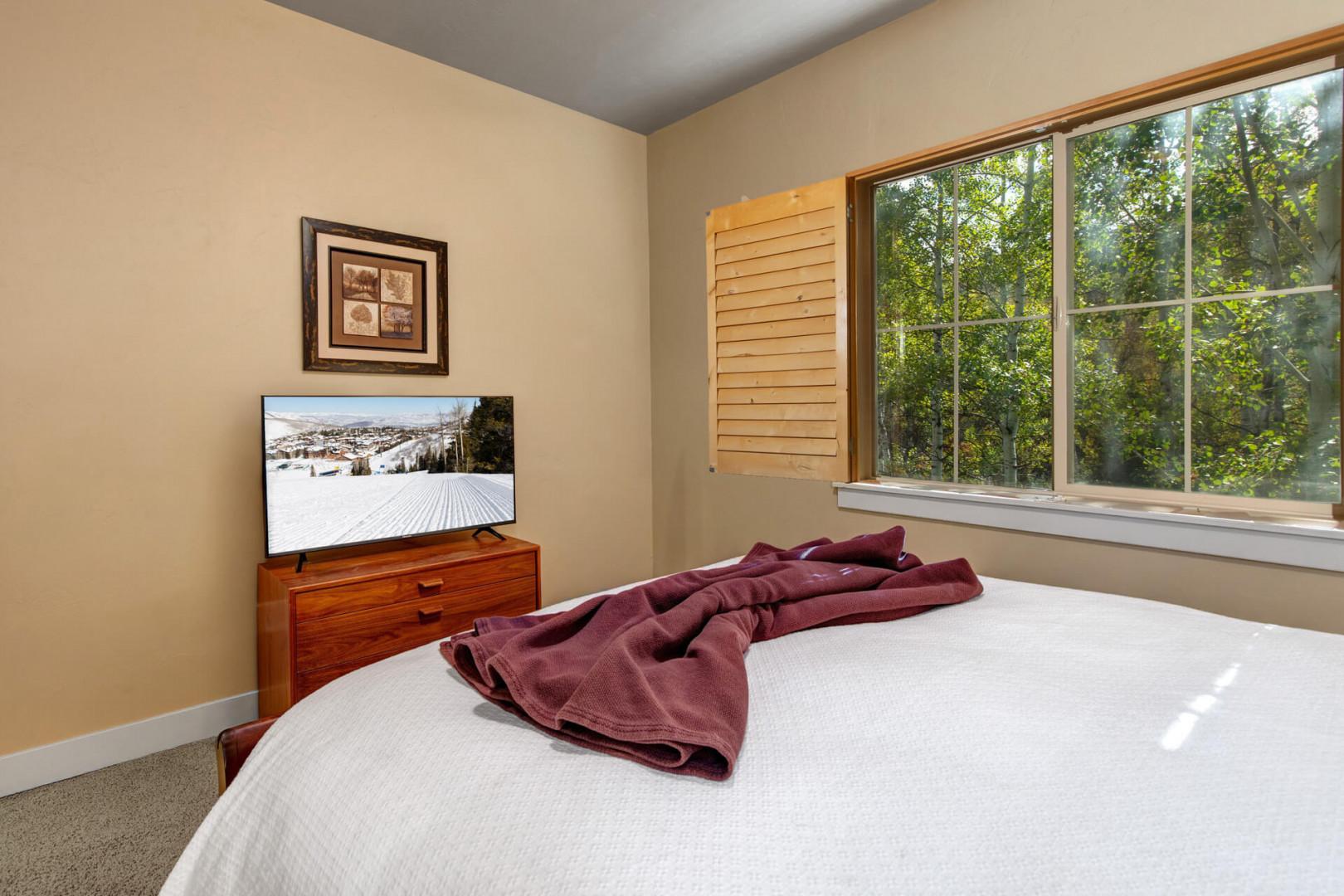 Wake up in your serene bedroom with garden views streaming through your window. Enjoy modern comforts like a flat-screen TV while feeling surrounded by nature.