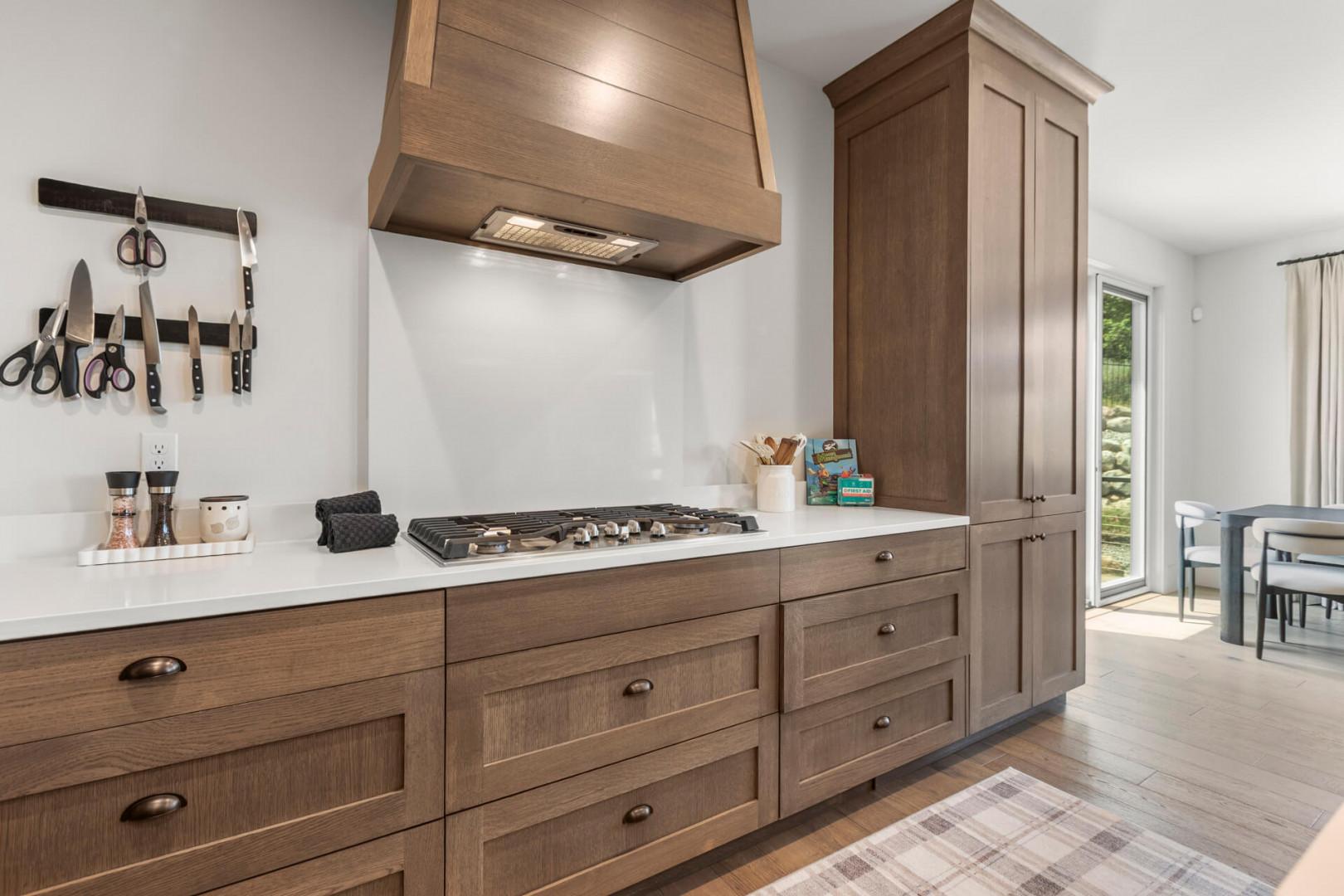 Craft your favorite meals at this beautifully designed kitchen with modern appliances, ample counter space, and warm wood cabinetry inviting you to create culinary memories.