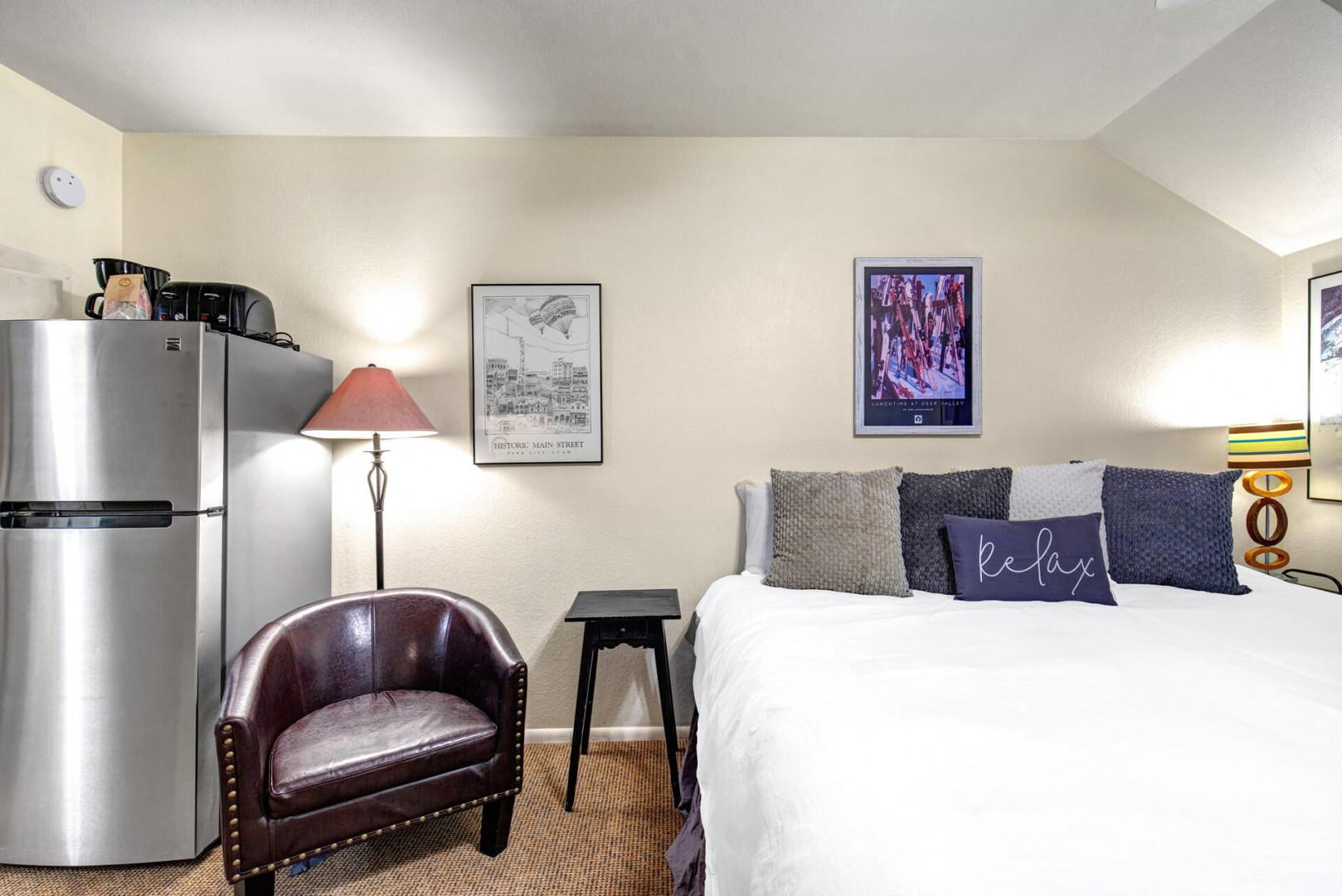 Your cozy retreat blends comfort with convenience—sink into crisp linens after exploring or whip up a snack in your mini fridge corner.