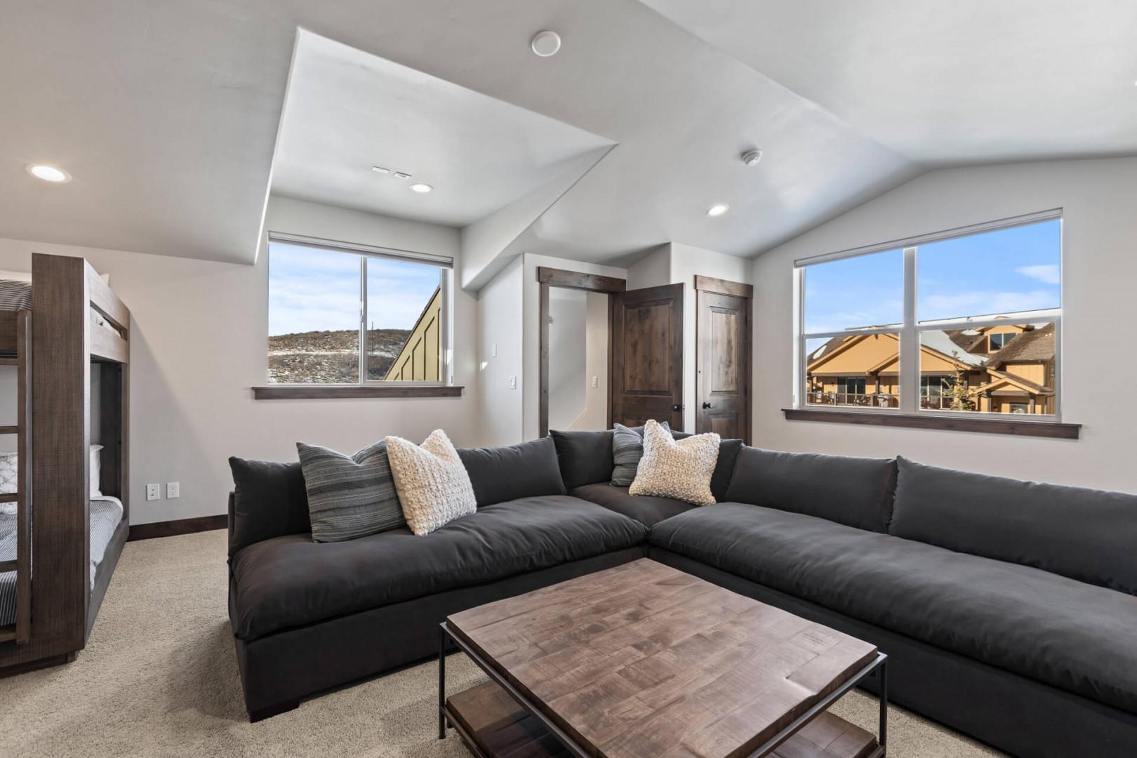 Black Rock Ridge 14536: Cozy space with a stylish sofa, center table, and natural light.