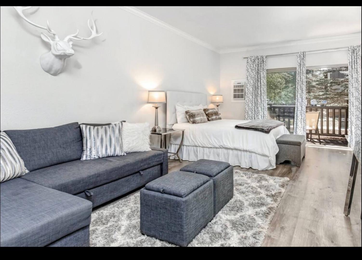 Relax in your stylish studio with plush seating, crisp linens, and peaceful balcony views—the perfect mountain retreat.