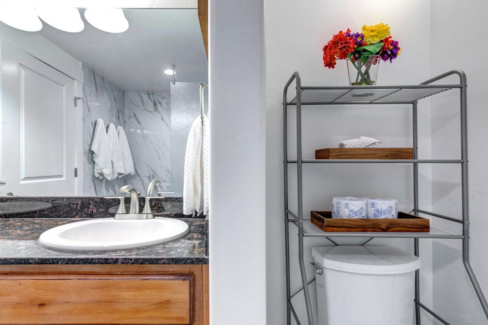 Fresh towels await you in this bright bathroom, thoughtfully organized for your comfort and convenience.