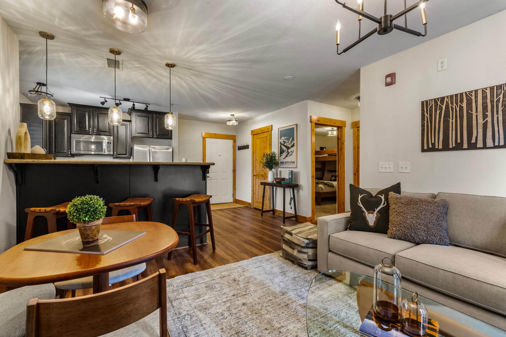 Step into your cozy mountain retreat, where warm wood accents and modern touches create the perfect home base for your getaway. Unwind on the plush sofa or gather around the inviting dining table after a day of adventure.