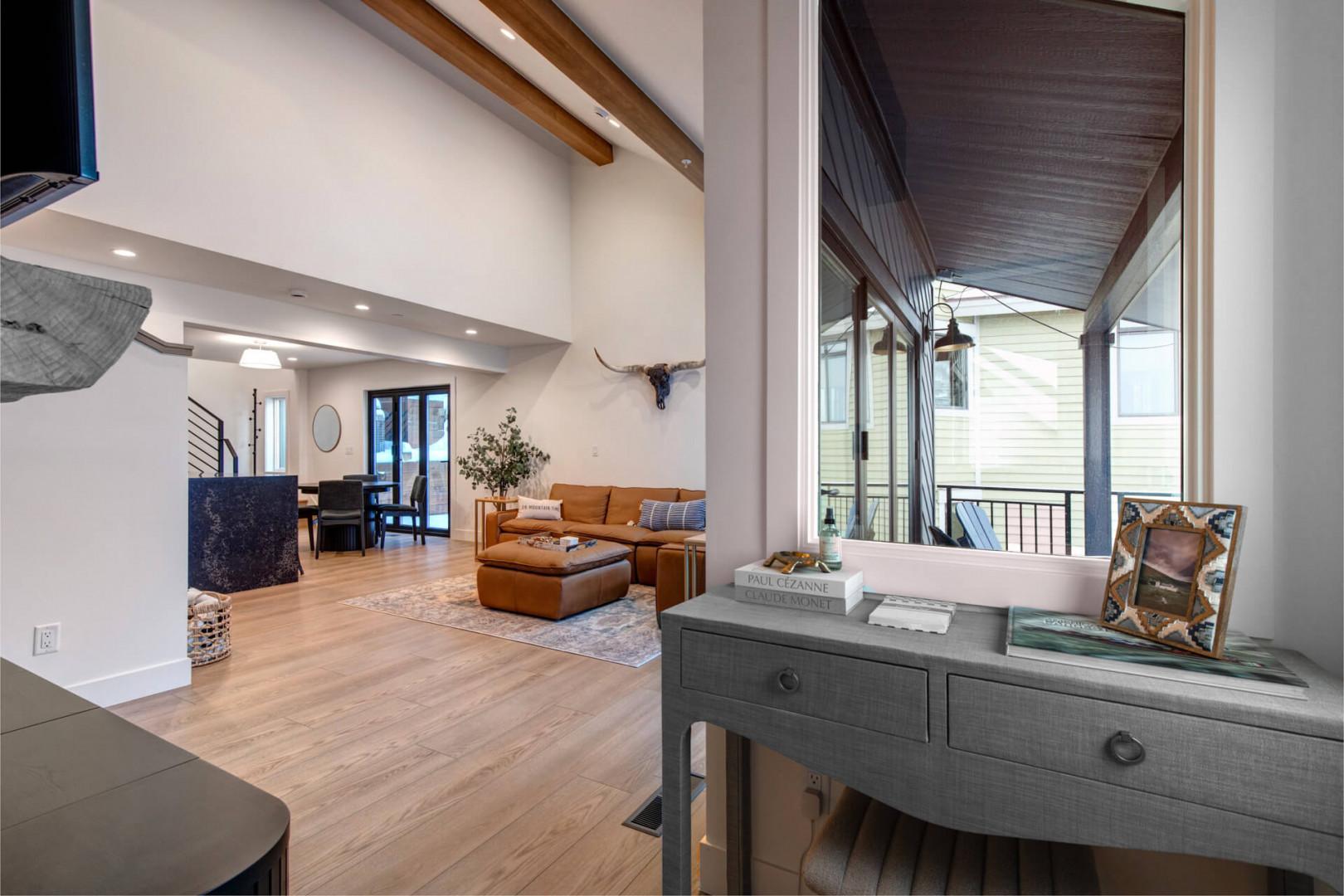 Upper Main 301: Unwind in your open-concept living space where soaring ceilings and warm wood beams create an airy, welcoming atmosphere for memorable gatherings.