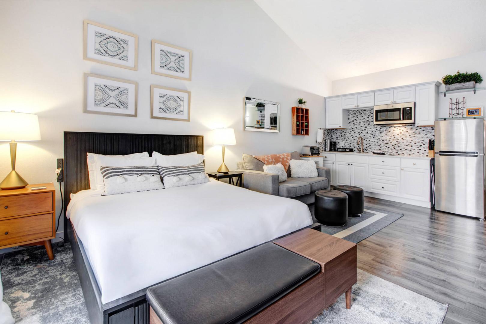 Your stylish studio combines comfort and convenience with a plush bed, modern kitchen, and cozy seating area—everything you need in one beautifully designed space.
