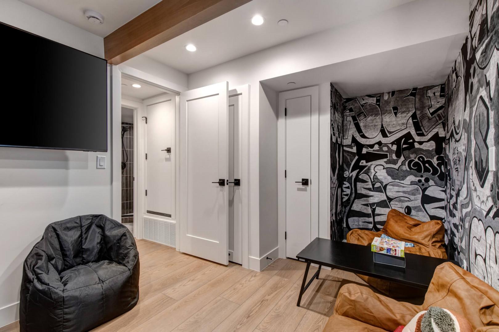 Upper Main 301: Relax in your modern living space with striking graffiti art, cozy seating, and entertainment - perfect for unwinding after exploring.
