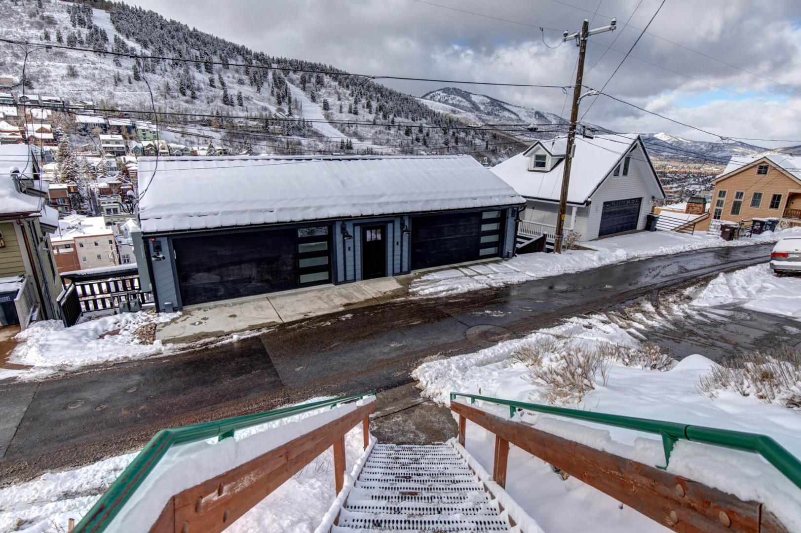 Modern mountain property nestled in a snowy ski town neighborhood with stunning alpine views.