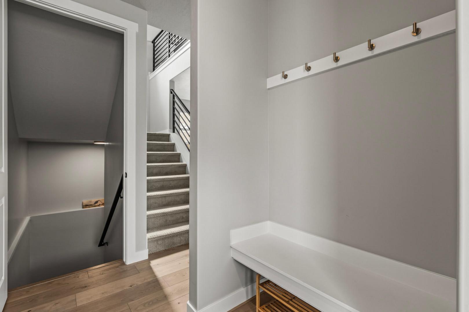 You'll love this stylish mudroom with built-in bench and coat hooks, perfect for storing your gear after exploring the city.