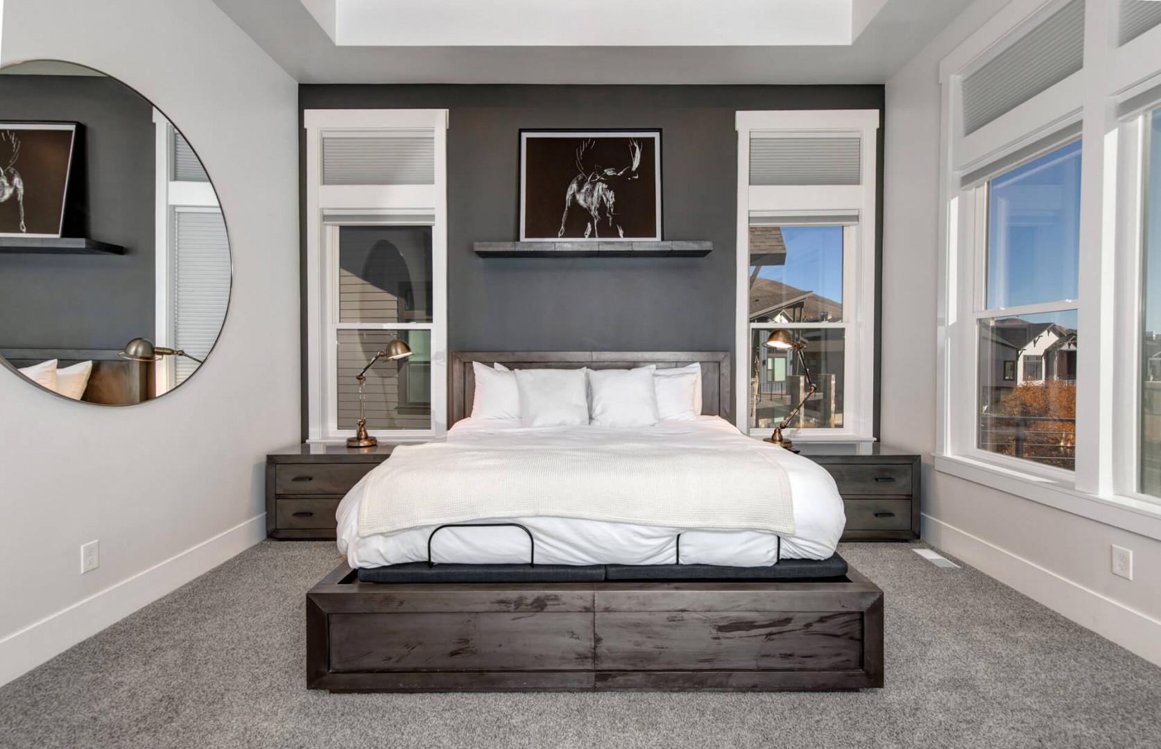 Deer Springs 12797: The primary bedroom suite features a luxurious king-size bed set against a slate accent wall.