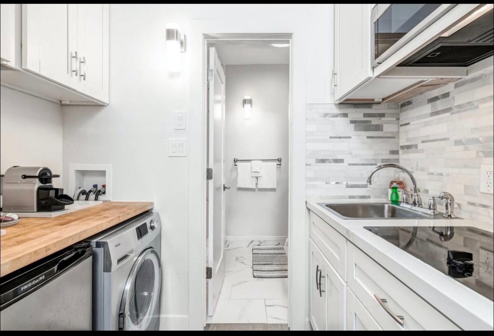 Your sleek galley kitchen features modern appliances, ample counter space, and convenient in-unit laundry for effortless meal prep and daily routines.