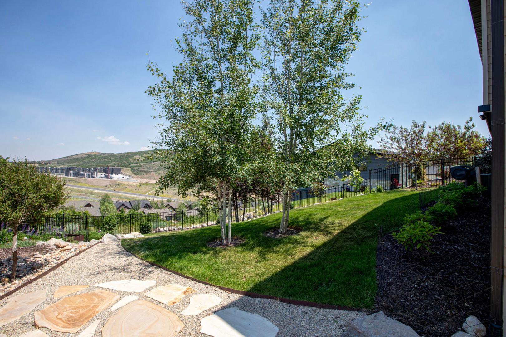 The property sits in a scenic hillside location with expansive natural landscape views across the surrounding neighborhood and rolling terrain beyond.