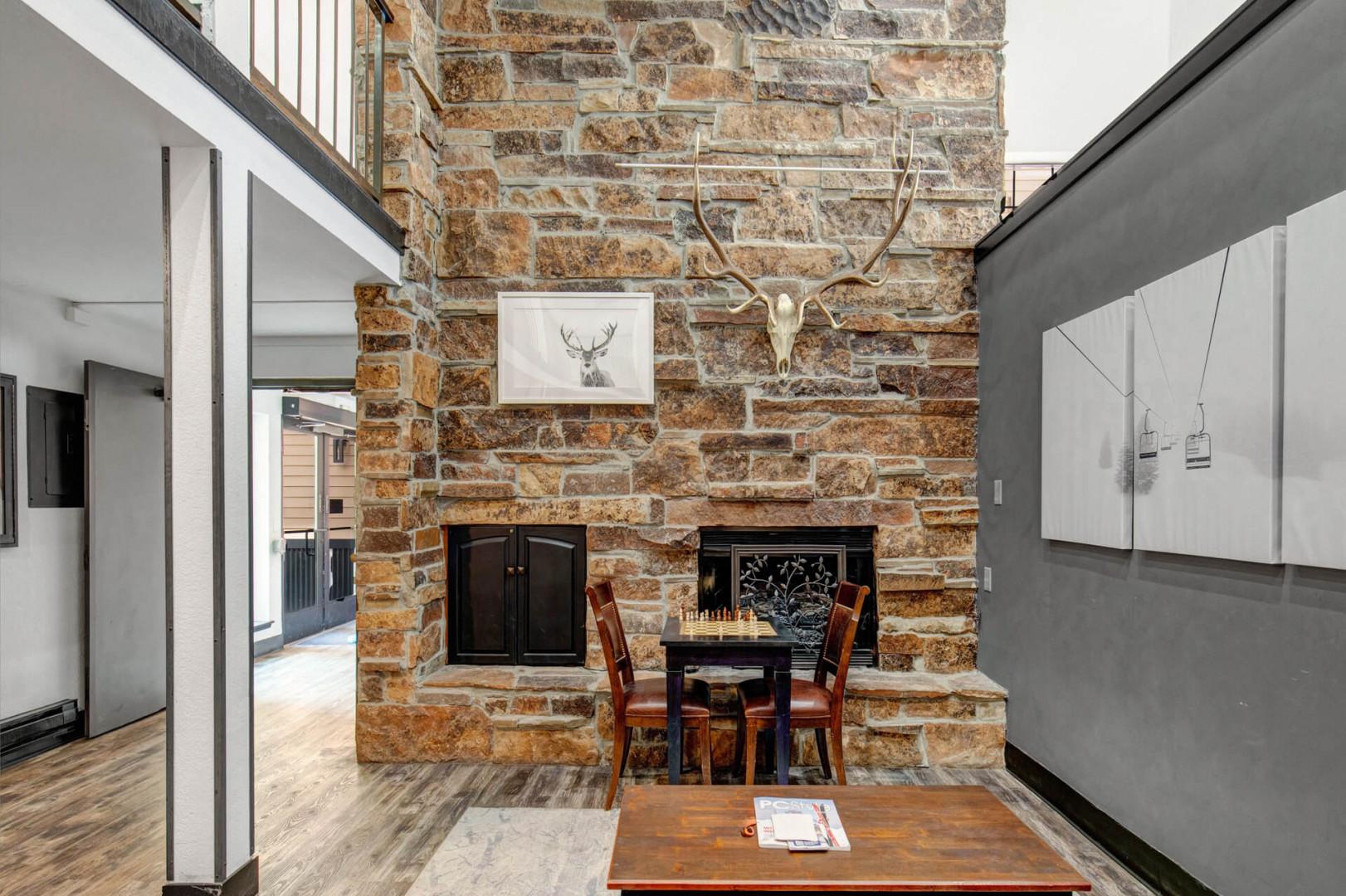 Unwind beside the towering stone fireplace, where rustic charm meets cozy alpine comfort—perfect for game nights and warm gatherings after a day of adventure.