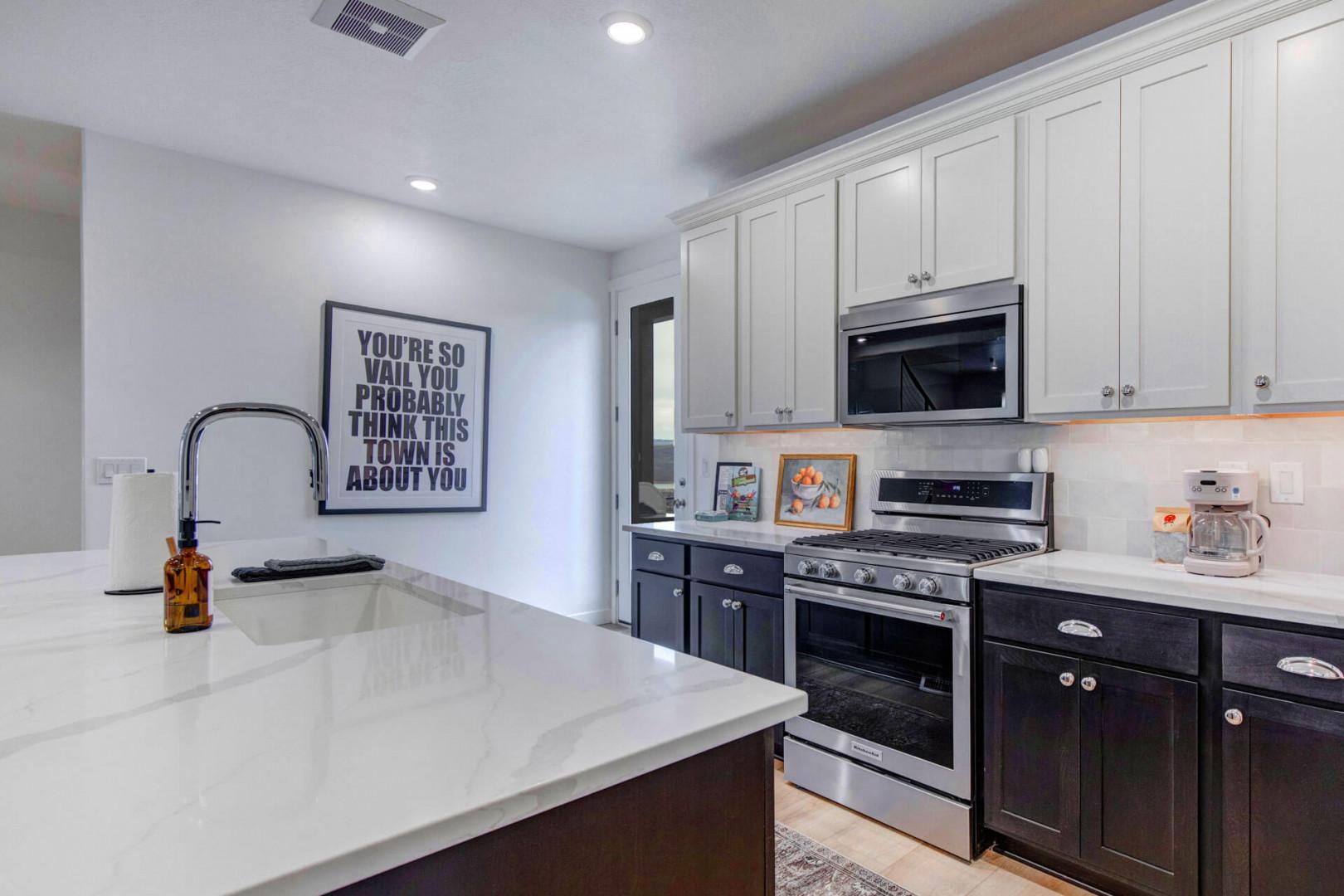 You'll love cooking in this modern kitchen with gleaming countertops, stainless appliances, and plenty of cabinet storage for your vacation essentials.