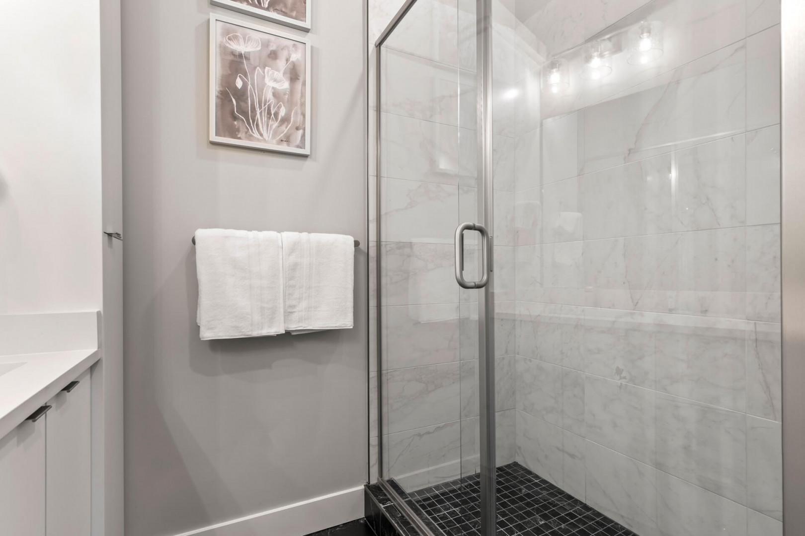 Mayflower Lakeside 301-45: Modern shower with sleek glass enclosure, a perfect oasis for relaxation.