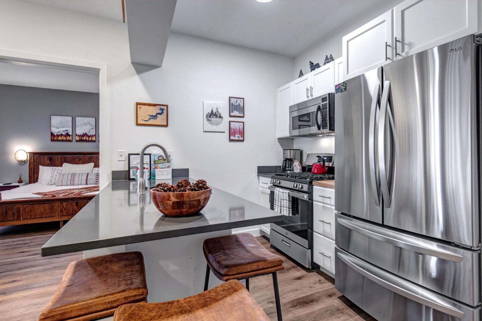 Your sleek modern kitchen features granite countertops, stainless steel appliances, and a breakfast bar perfect for morning coffee or evening snacks.