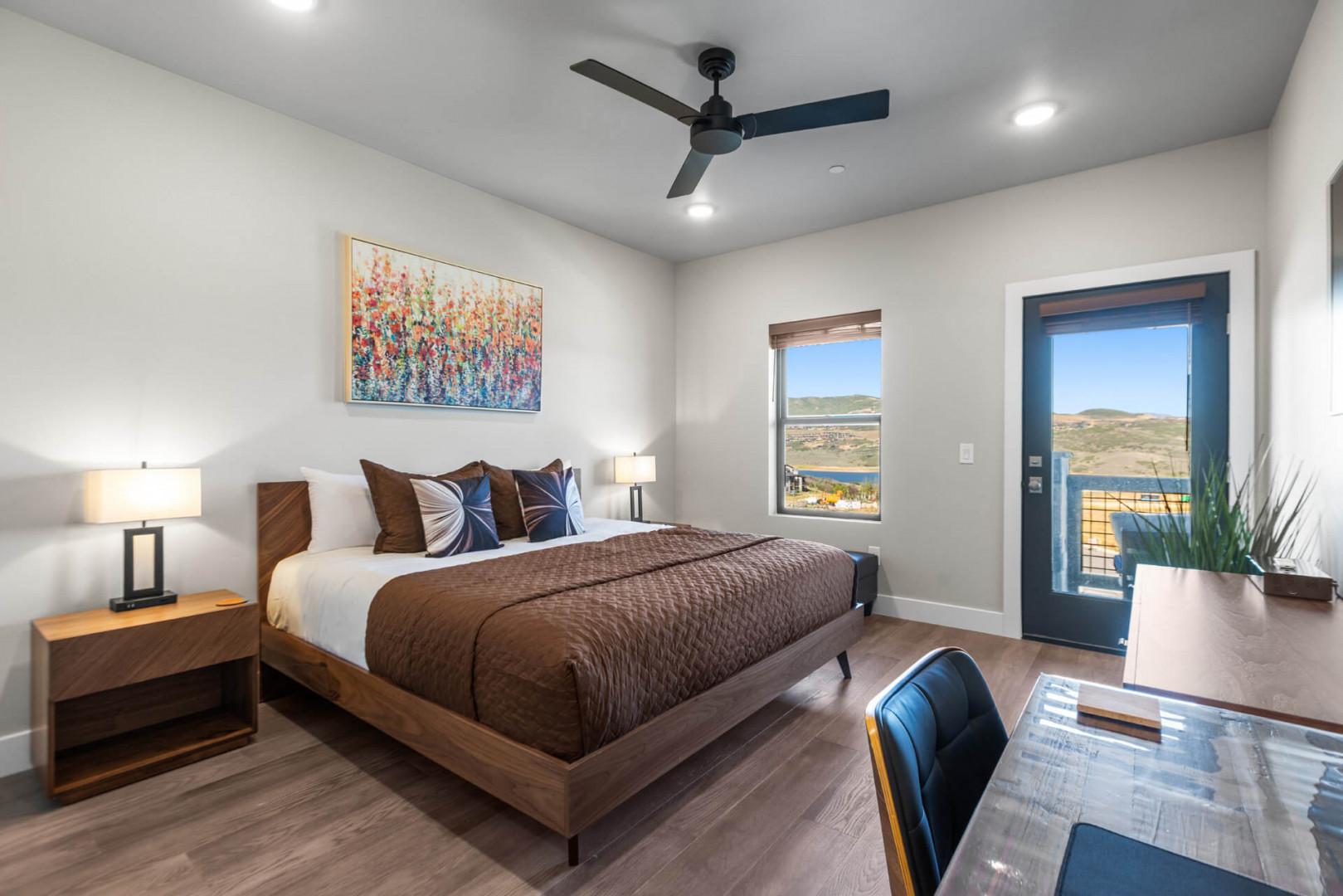 Wake up to serene lake and hillside vistas from your cozy bedroom. Warm tones and modern touches invite you to unwind—your perfect retreat awaits.