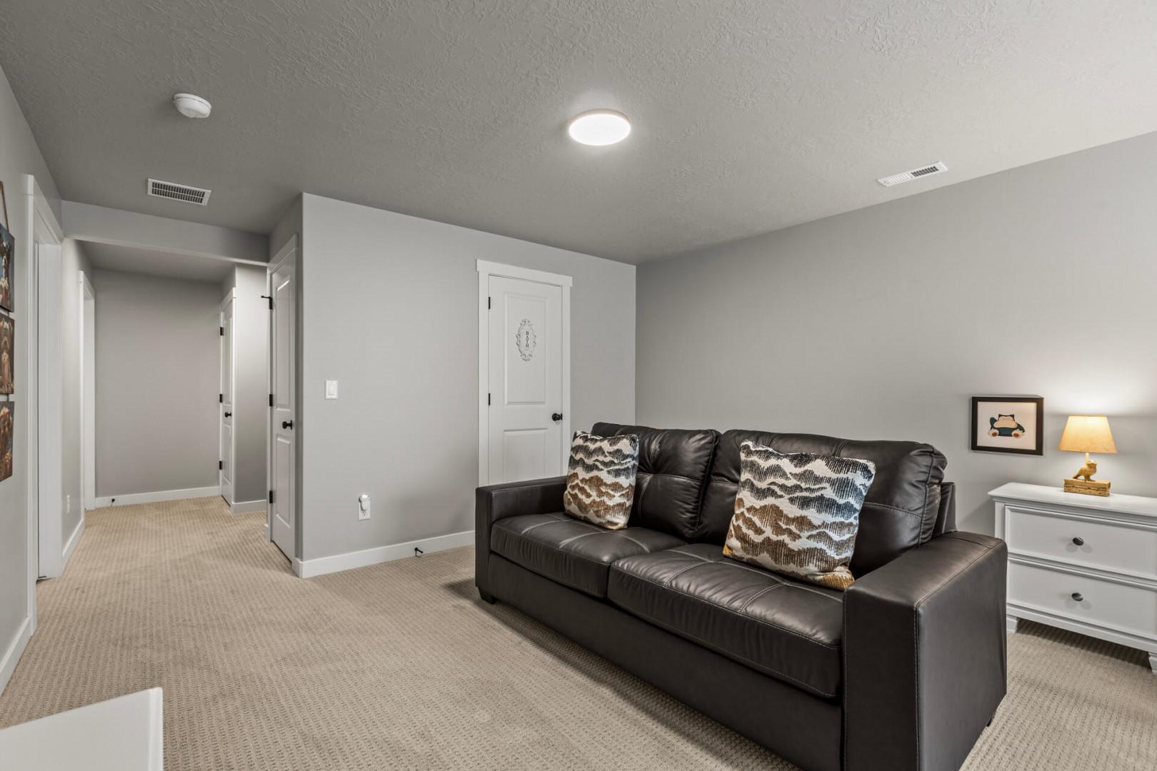 Unwind in your private basement retreat with plush leather seating and warm lighting for peaceful relaxation.