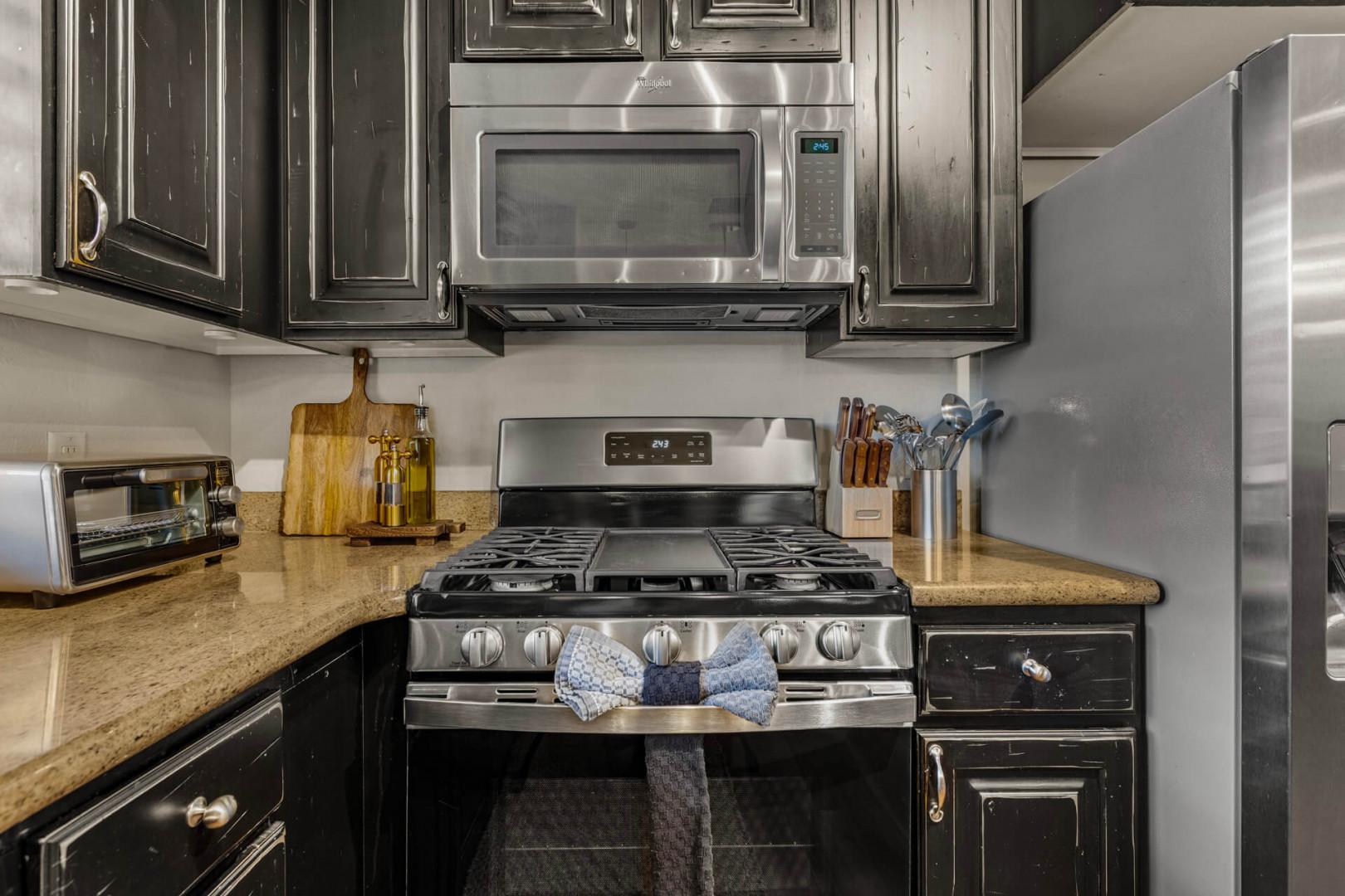 Your fully-equipped kitchen awaits, featuring sleek stainless steel appliances and ample counter space for preparing your favorite meals during your stay.