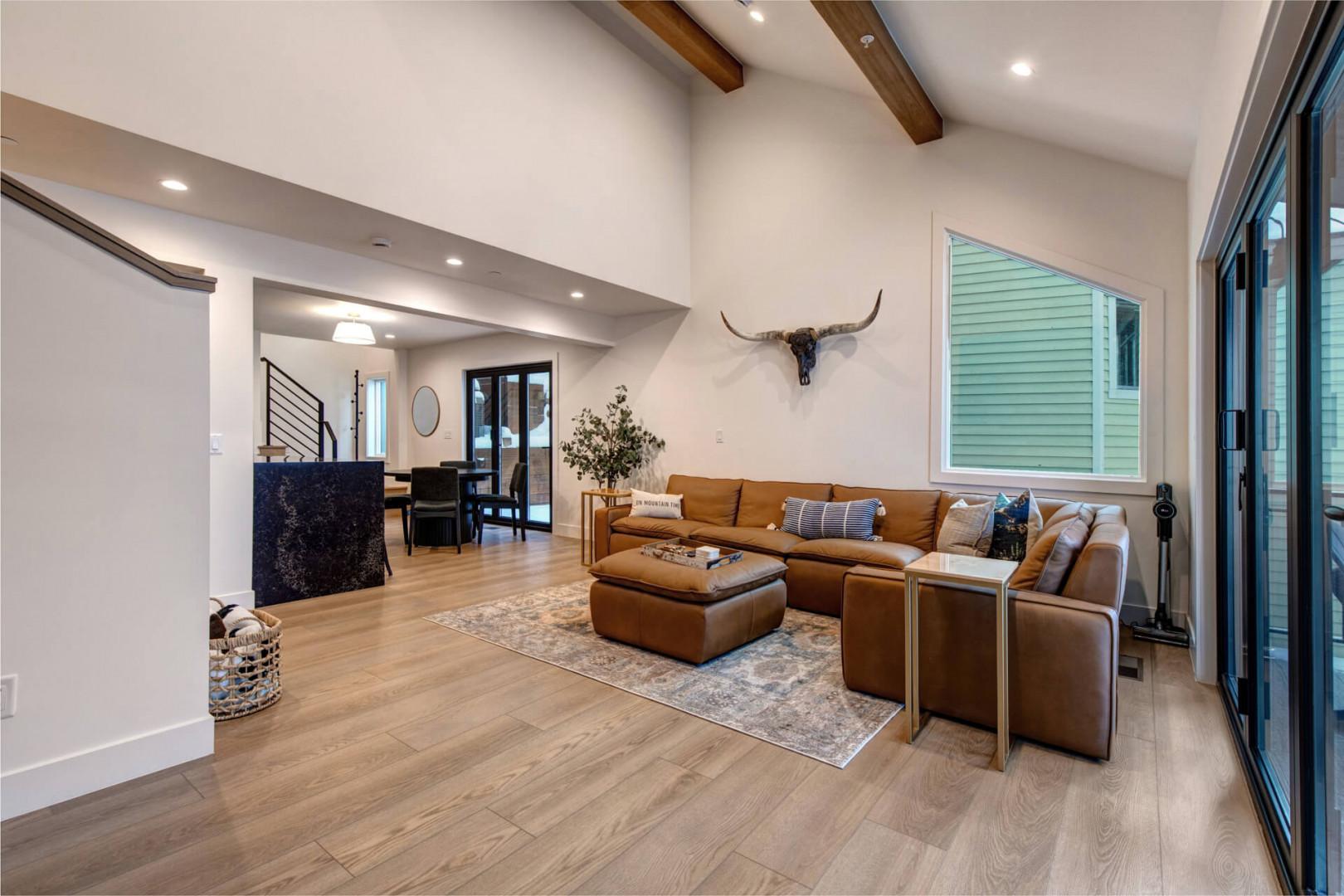 Upper Main 301: Sink into this plush leather sectional where rustic beams meet modern elegance, perfect for your evening unwind sessions.
