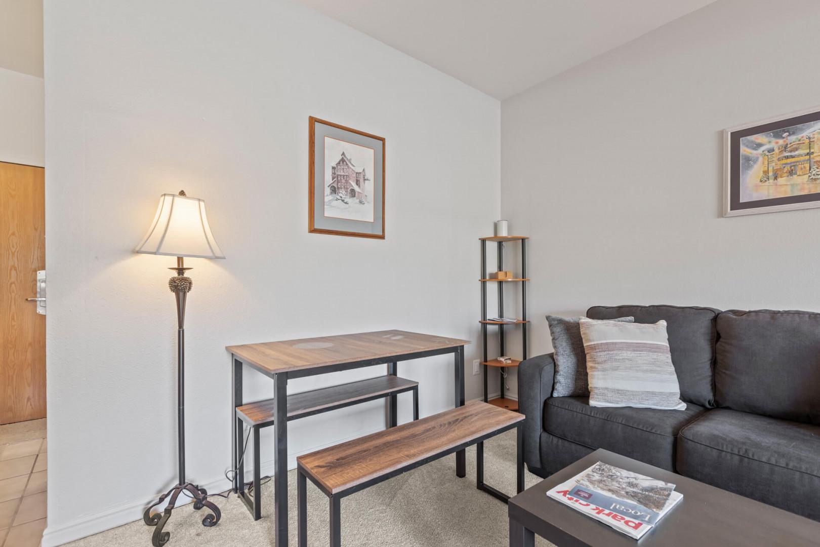 Cozy dining area next to comfortable sofa chair in stylish decor.