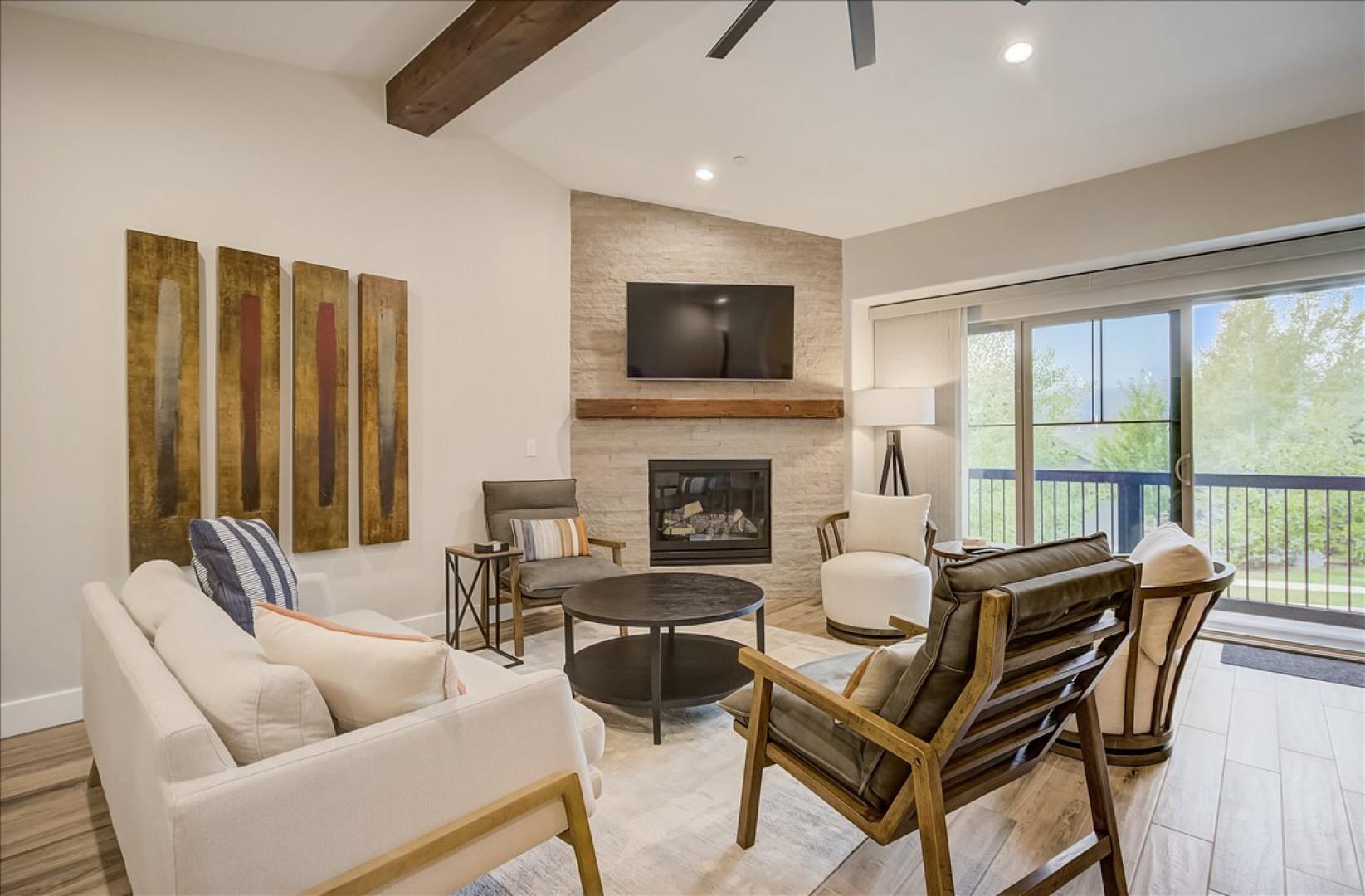 Black Rock Ridge 14202: Living Room: "Cozy corner with fireplace, TV, and balcony view through sliding door."