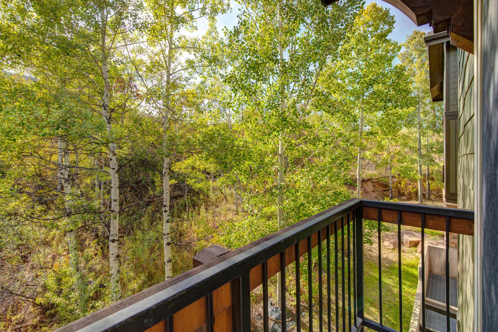 Private balcony overlooks tranquil aspen groves, providing a peaceful retreat for morning coffee or quiet afternoon moments in nature.