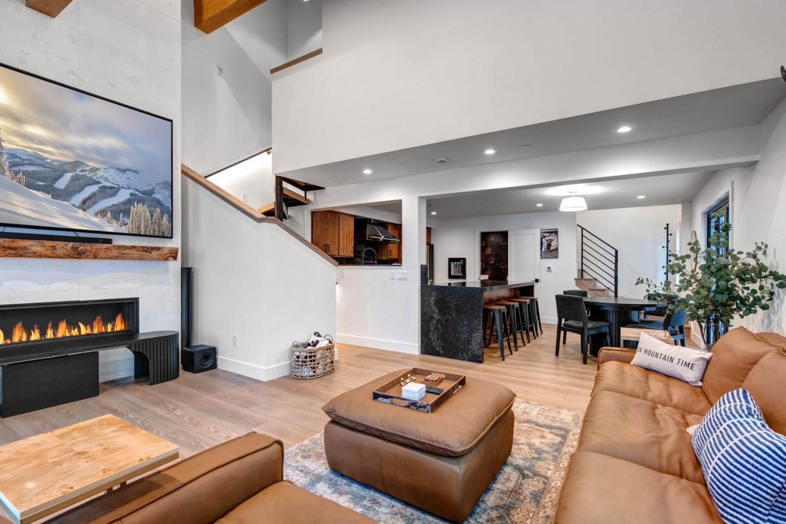 Upper Main 301: Sink into luxurious leather seating beside your crackling fireplace in this stunning open-concept living space with soaring ceilings.