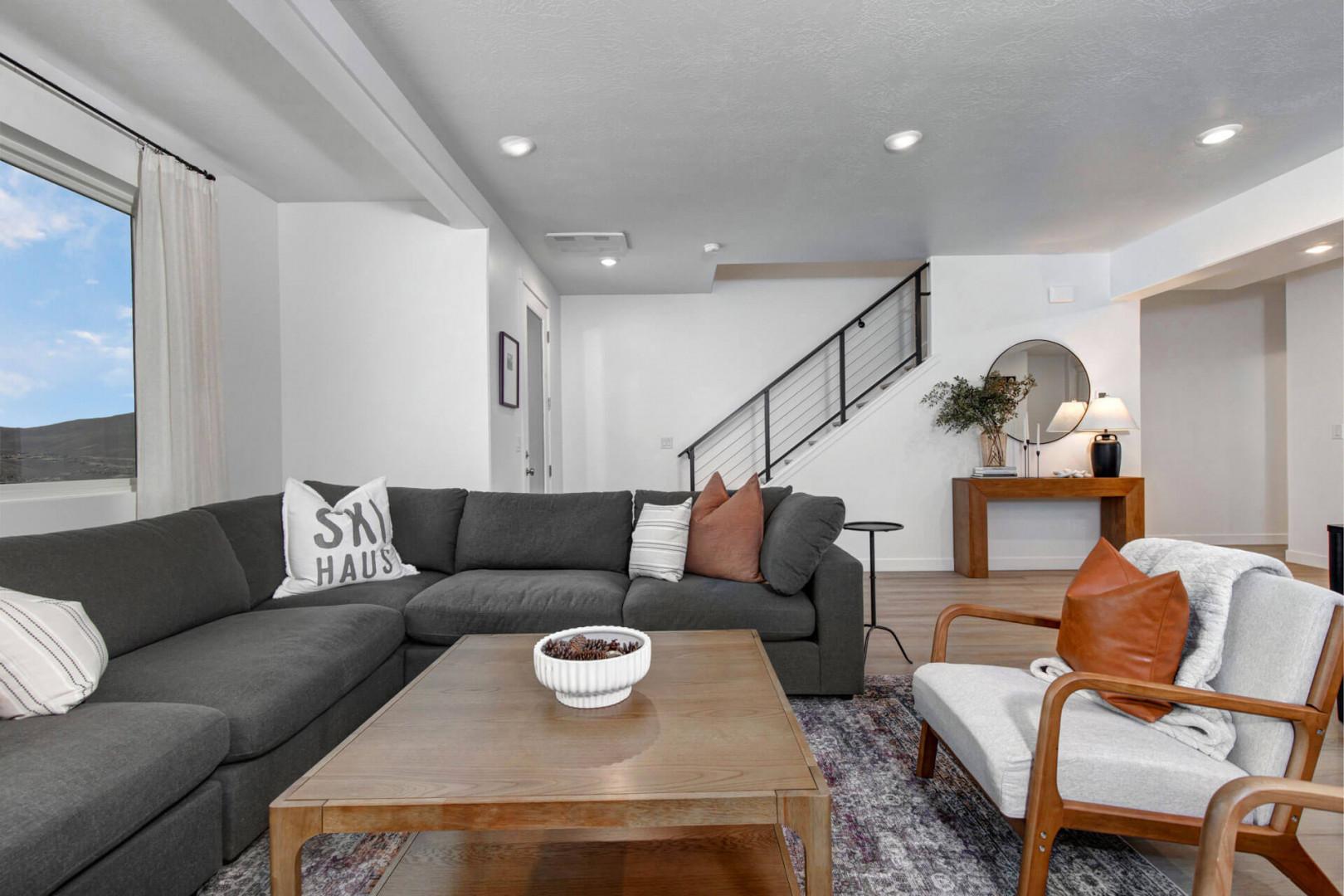 Sink into your spacious sectional and enjoy the open-concept design with modern touches throughout this bright, airy living space.
