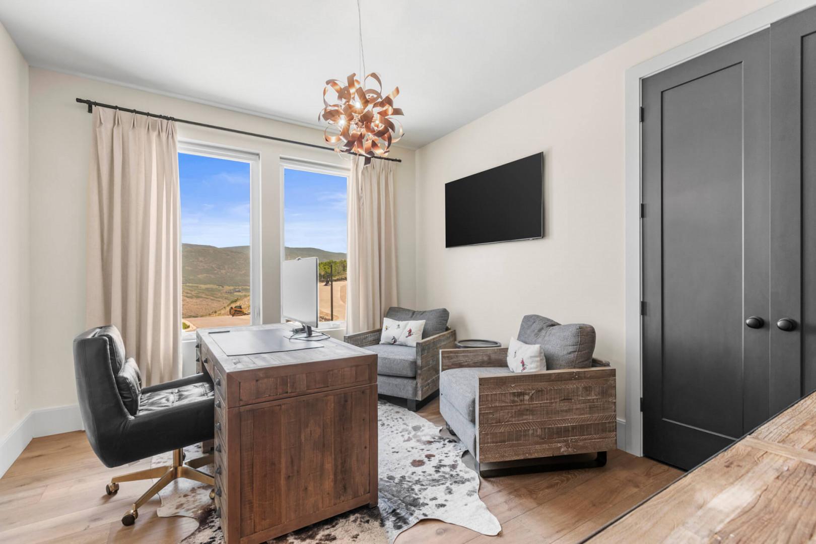 Step into your private workspace on the main level across from the primary bedroom with mountain views, rich wood furnishings, and cozy seating—perfect for catching up on emails or simply unwinding.