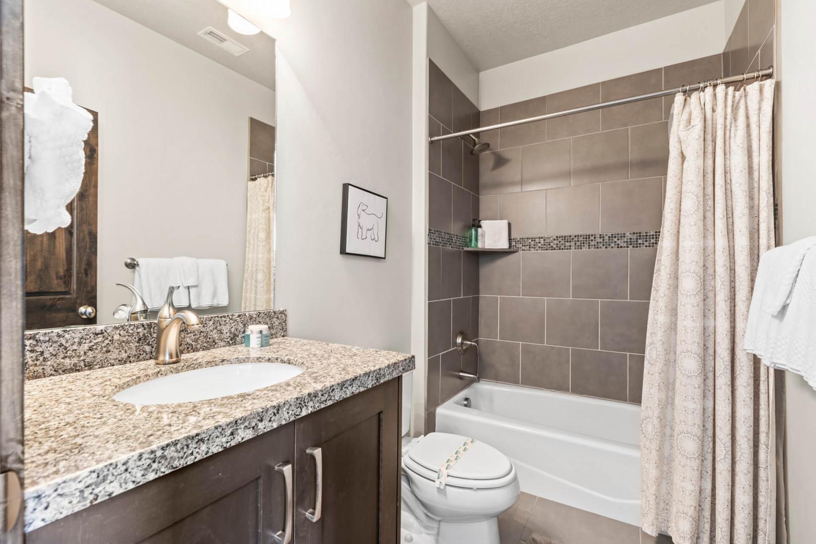 Your private bathroom offers granite countertops, modern fixtures, and a relaxing tub-shower combo for unwinding after your adventures.
