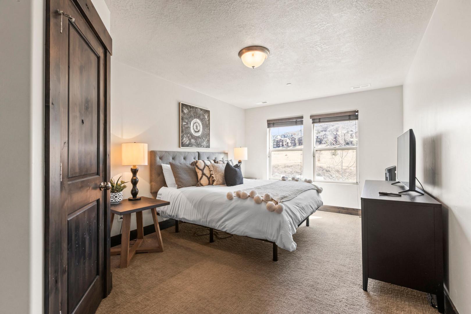 Sink into your cozy retreat with mountain views, plush bedding, and warm modern touches that make relaxation effortless.