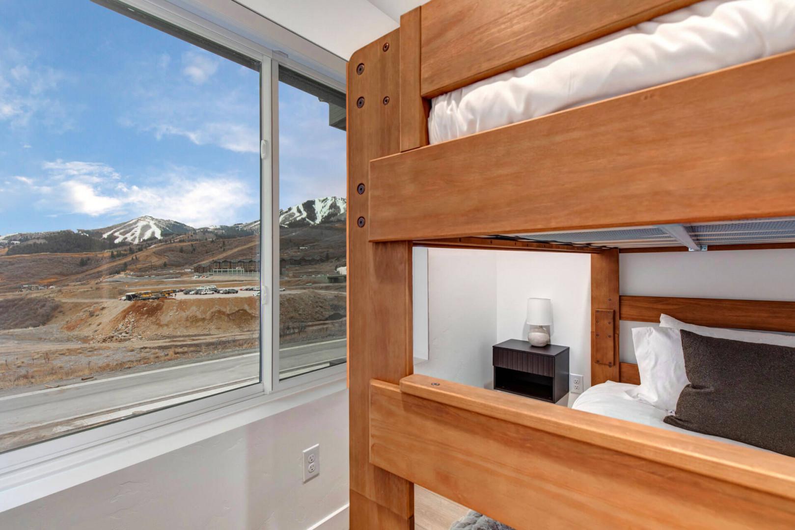 Sleep soundly in your cozy bunk while taking in breathtaking mountain views through the expansive windows.