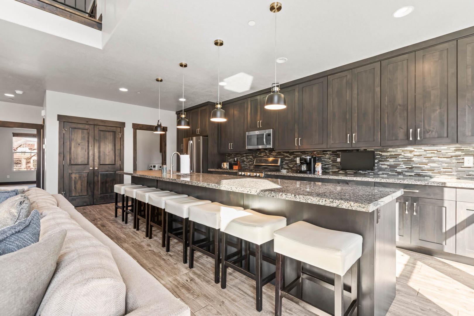 You'll love gathering in this spacious chef's kitchen, where a stunning island with granite counters and stylish seating invites conversation and effortless entertaining.
