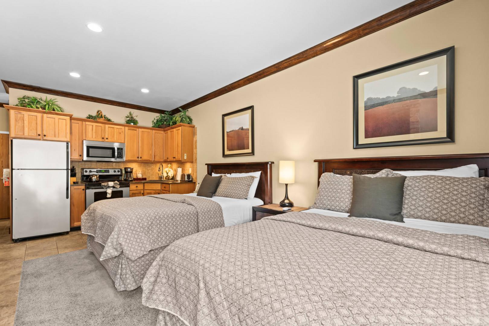 Your spacious suite combines comfort and convenience with two plush beds, a full kitchen, and thoughtful decor—everything you need for a restful, memorable stay.