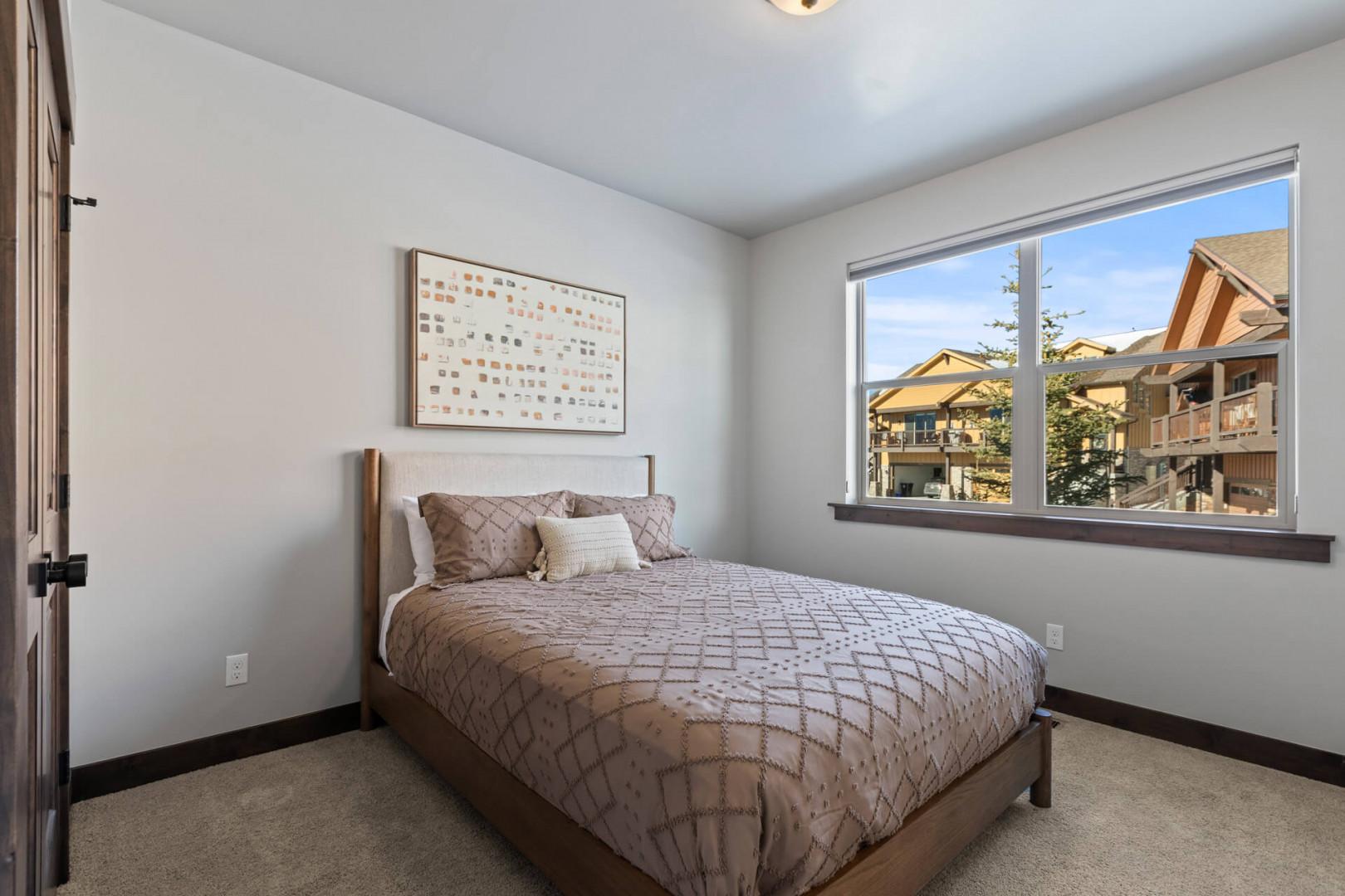 Black Rock Ridge 14536: Cozy bed by the window, perfect for a relaxing afternoon nap.