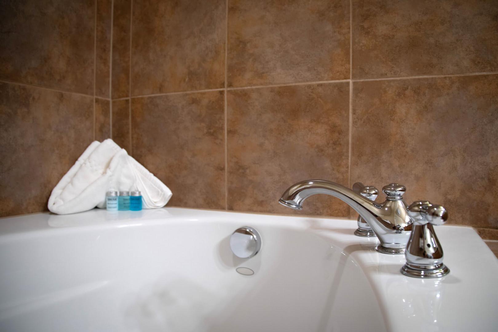 Sink into the gleaming soaking tub with fresh towels and luxury amenities ready at hand for your ultimate relaxation.