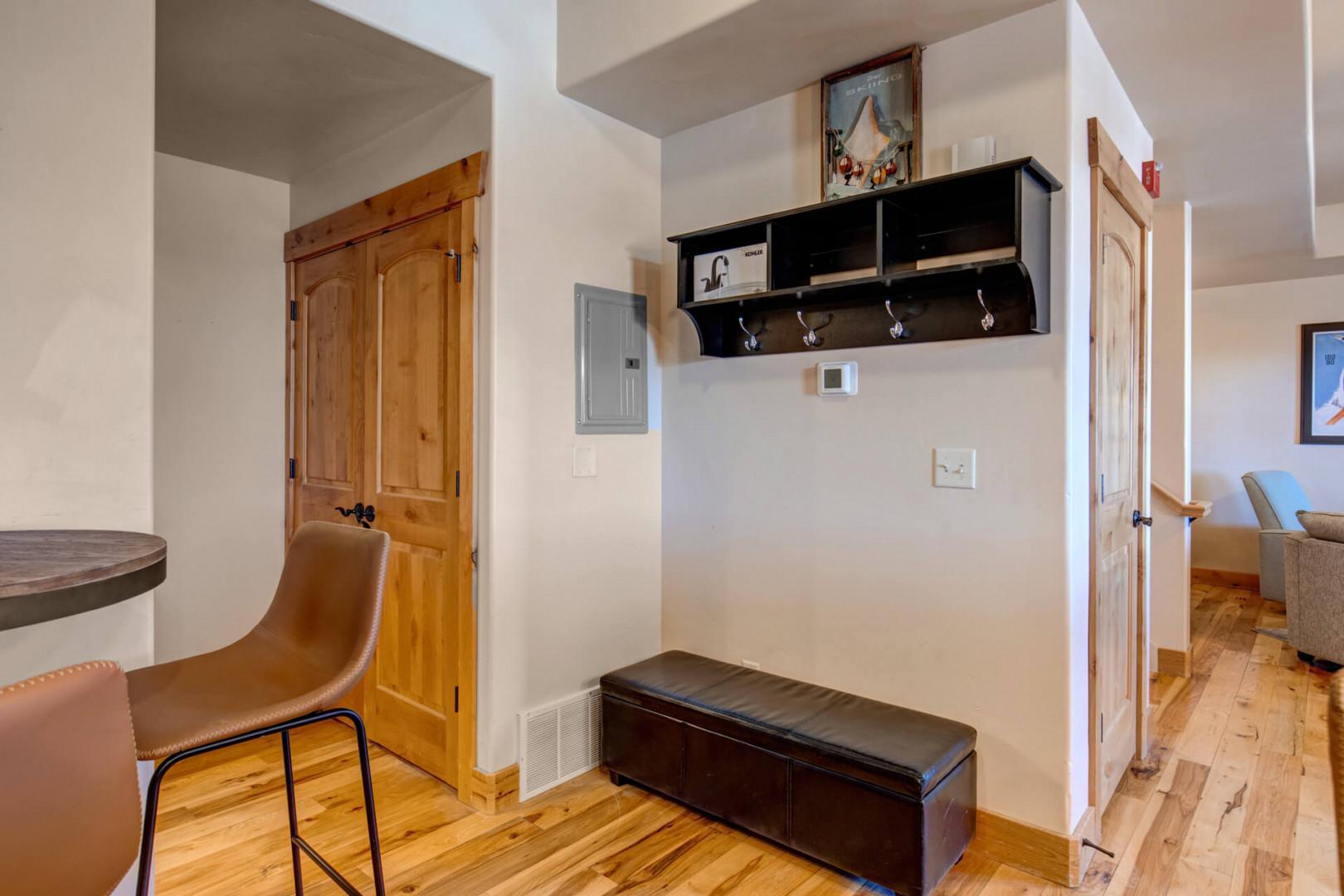 Step into your welcoming entryway where warm wood floors and thoughtful touches create the perfect arrival experience.