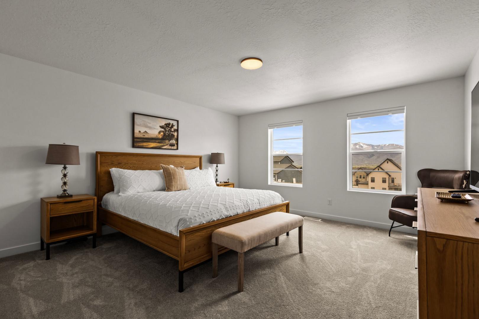 Relax in your peaceful bedroom with mountain views and warm wood furnishings for a restful night's sleep.