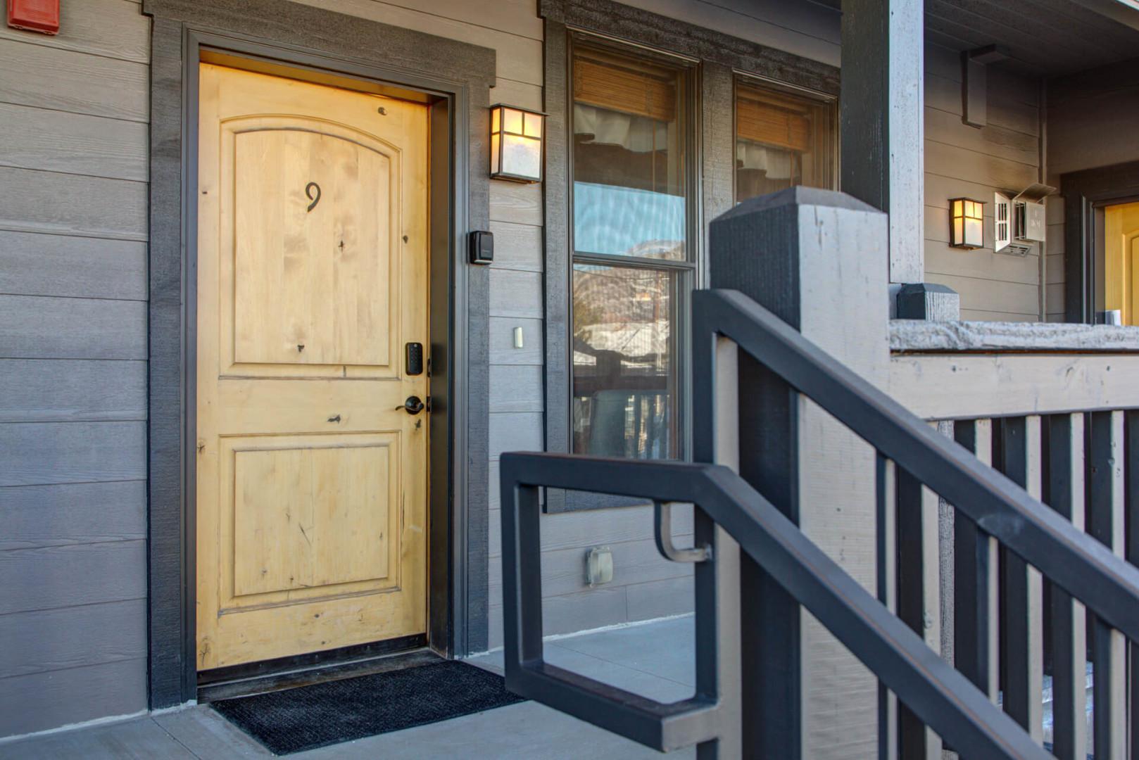 Modern property entrance with accessible design features and covered entry walkway.