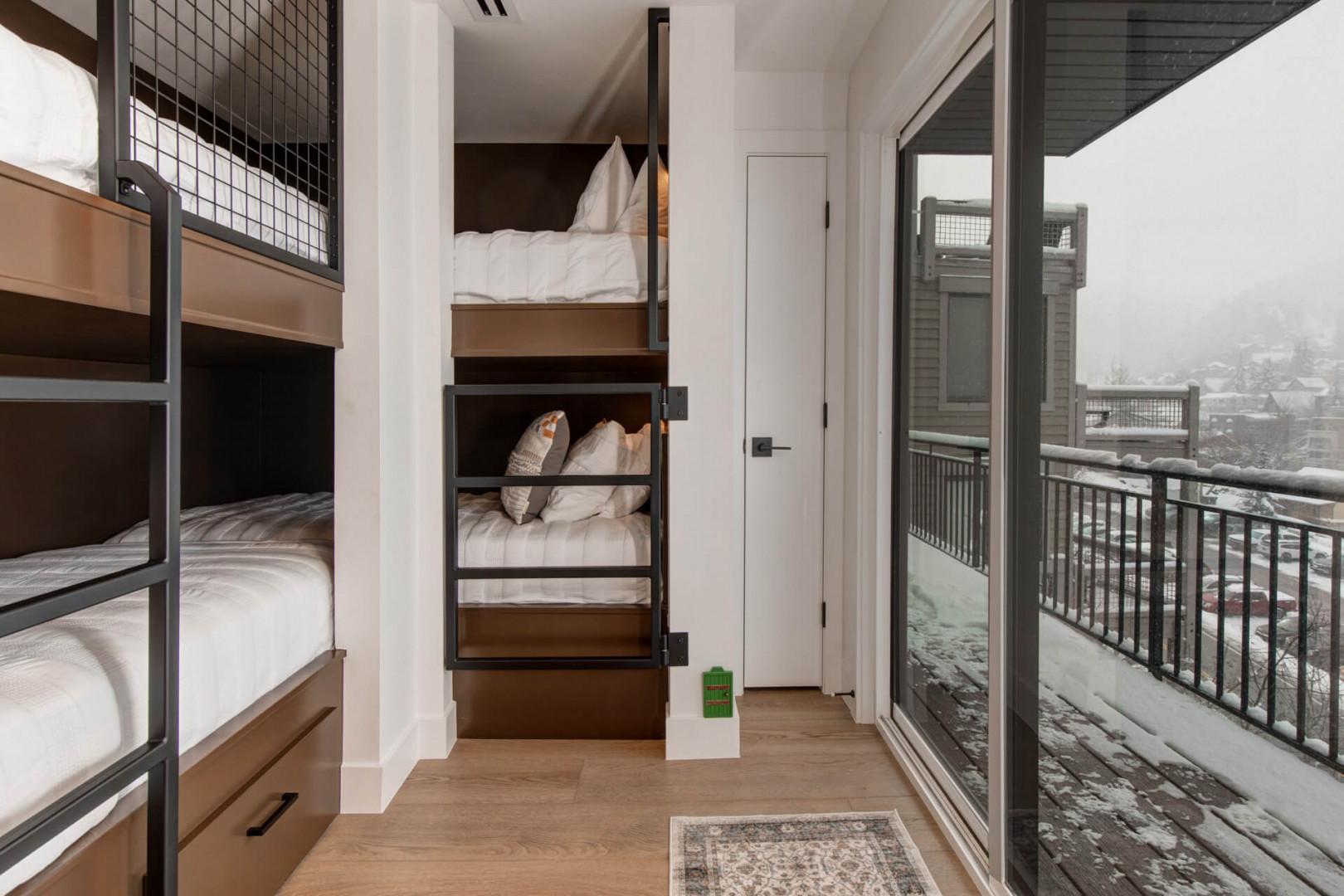 Upper Main 301: Cozy bunk beds with crisp linens and mountain views create your perfect retreat for friends or family adventures.