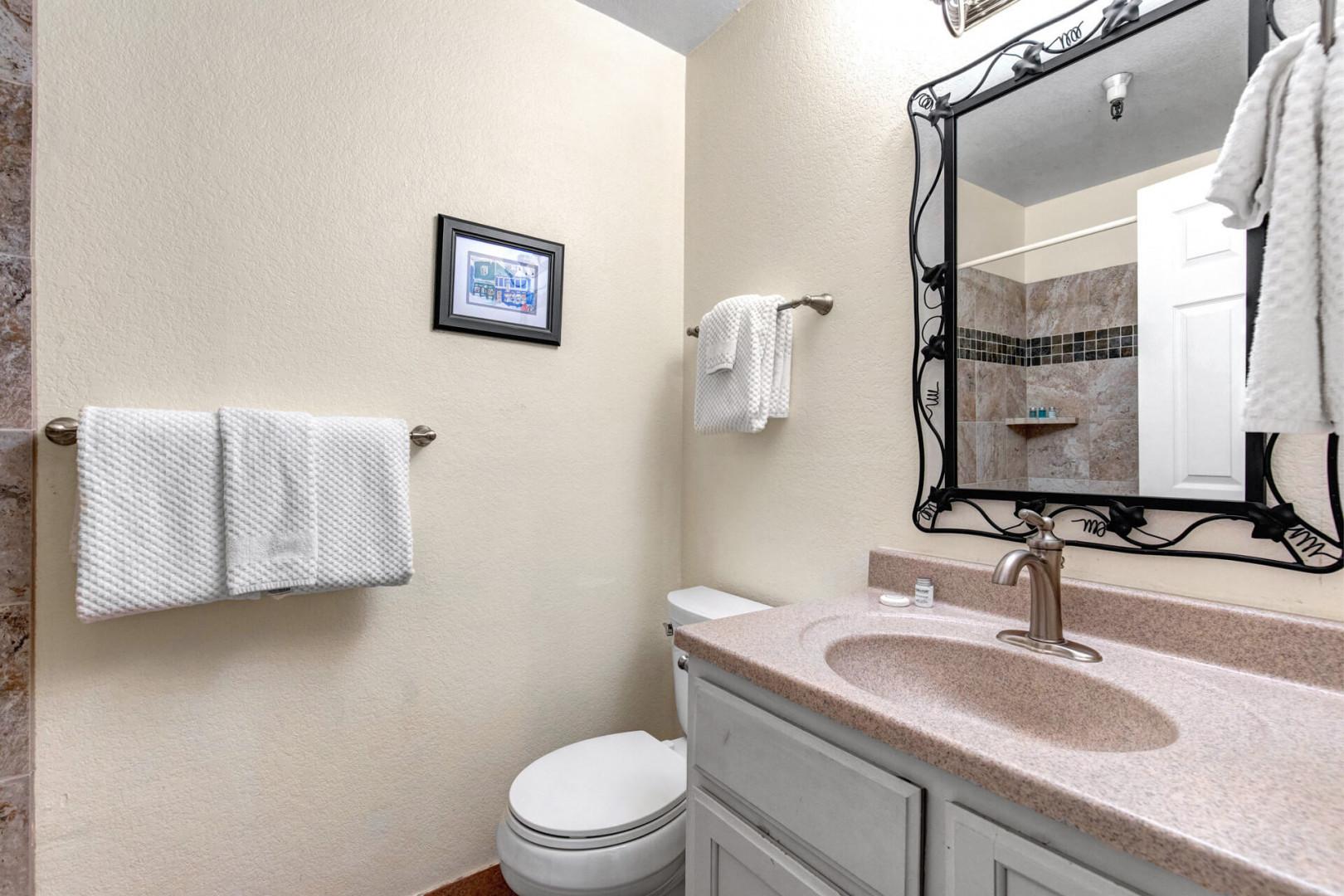 Freshen up in your private bathroom with a large vanity, soft towels, and a walk-in shower—everything you need for a comfortable stay.