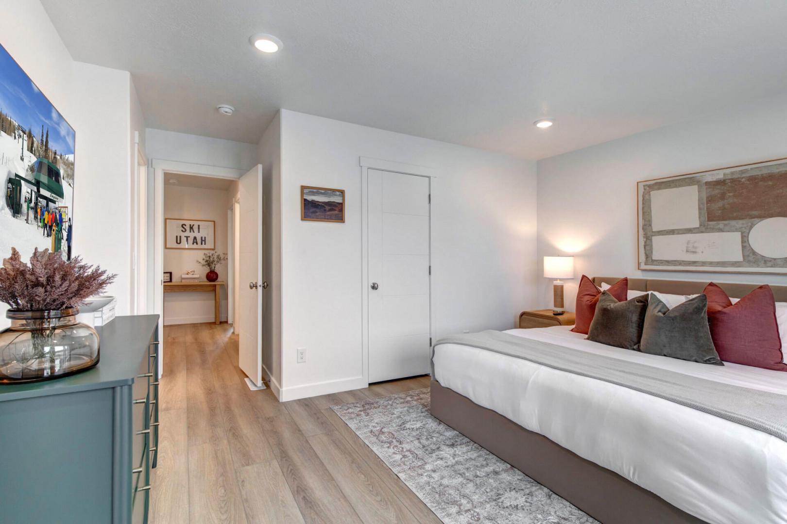 Sink into your king-size bed surrounded by colorful pillows and warm lighting for the perfect mountain getaway retreat.