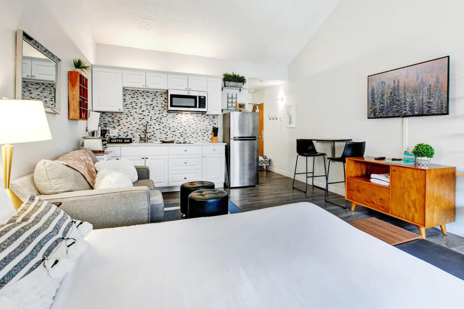 Your stylish studio blends modern comfort with thoughtful touches - crisp linens, fully-equipped kitchen, and cozy seating perfect for unwinding.