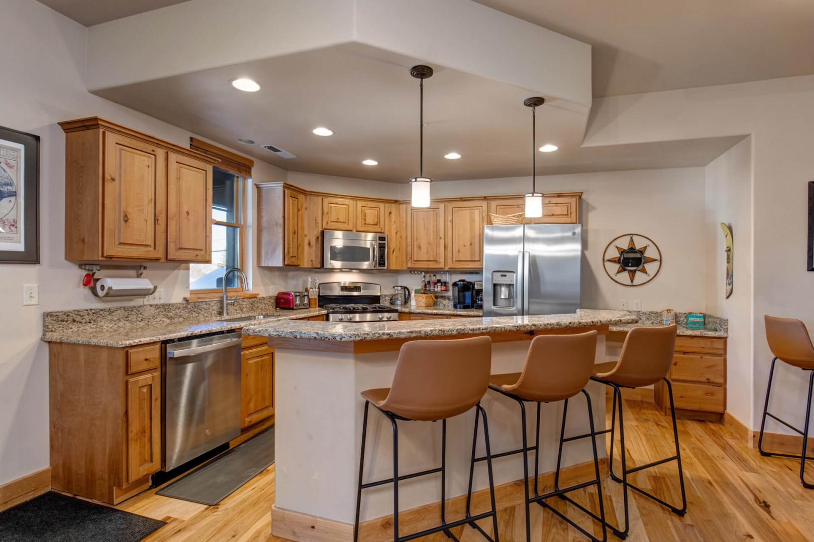 Your spacious kitchen features granite counters, stainless steel appliances, and a breakfast bar where you'll enjoy morning coffee together.