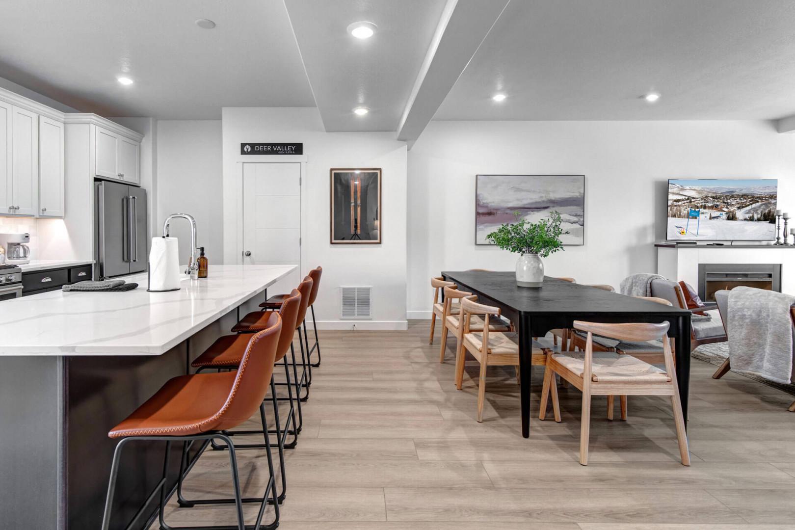 Your spacious kitchen flows into a stylish dining area with leather bar stools and contemporary artwork creating the perfect space for meals together.